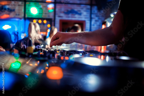 Dj playing disco house progressive electro music at the concert. DJ hands on equipment