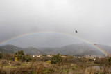 Helicopter going through the rainbow in the Santillana de Manzanares el Real reservoir in Madrid
