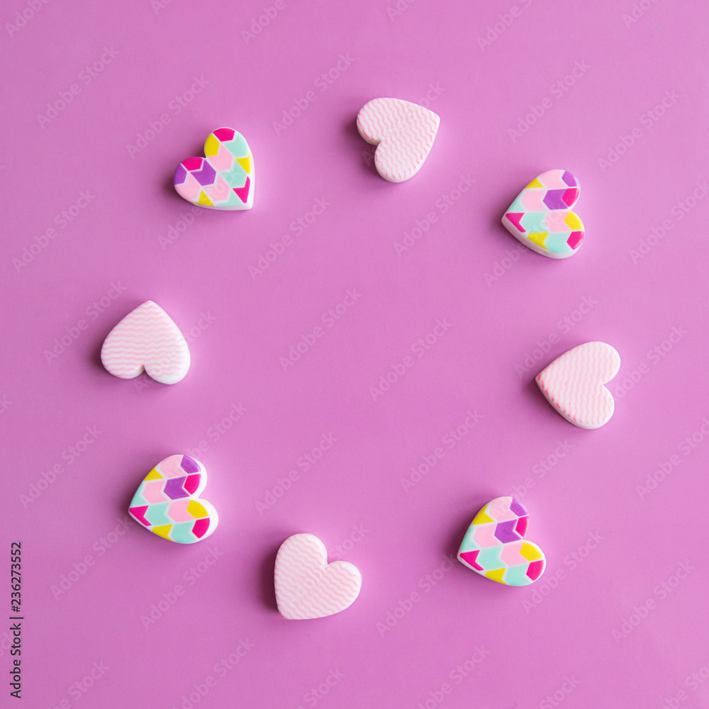 Obraz premium Valentine's Day concept - close up frame of hearts. Pink background. Copy space for text. View from above.