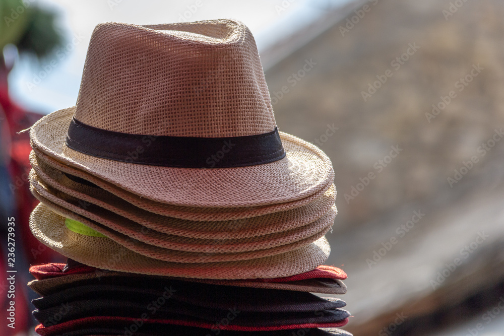 Stack of straw fedora hats
