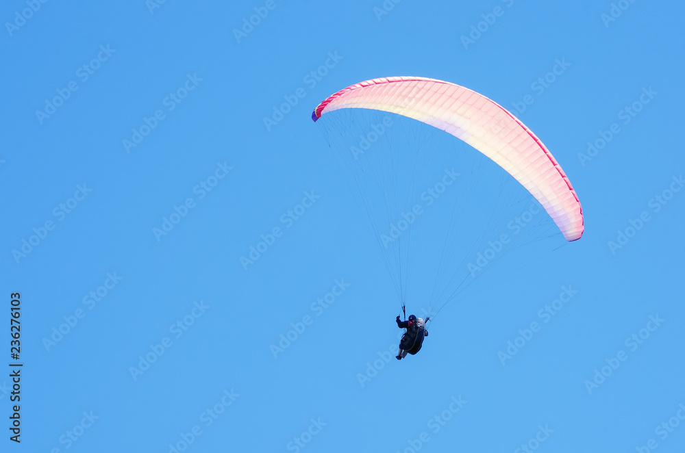Paraglider against the sky. Russia, Republic of Crimea. 06.13.2018. Flight of a paraglider athlete against the sky Paraglider against the sky. Russia, Republic of Crimea. 06.13.2018. Flight of a paraglider athlete against the sky