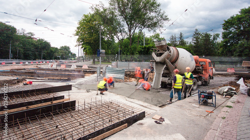 Concrete works for road maintenance construction with many workers and mixer timelapse