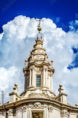 The dome of Sant Ivo alla Sapienza against the backdrop of an incredible blue sky with fluffy white clouds. Rome. Italy