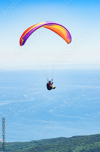 Paraglider over the sea coast. Russia, Republic of Crimea. 06.13.2018. Flight of a paraglider athlete over the sea coast in the area of Mount Ai-Petri
