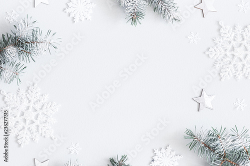 Christmas composition. Frame made of fir tree branches, decorations on pastel gray background. Christmas, winter, new year concept. Flat lay, top view, copy space
