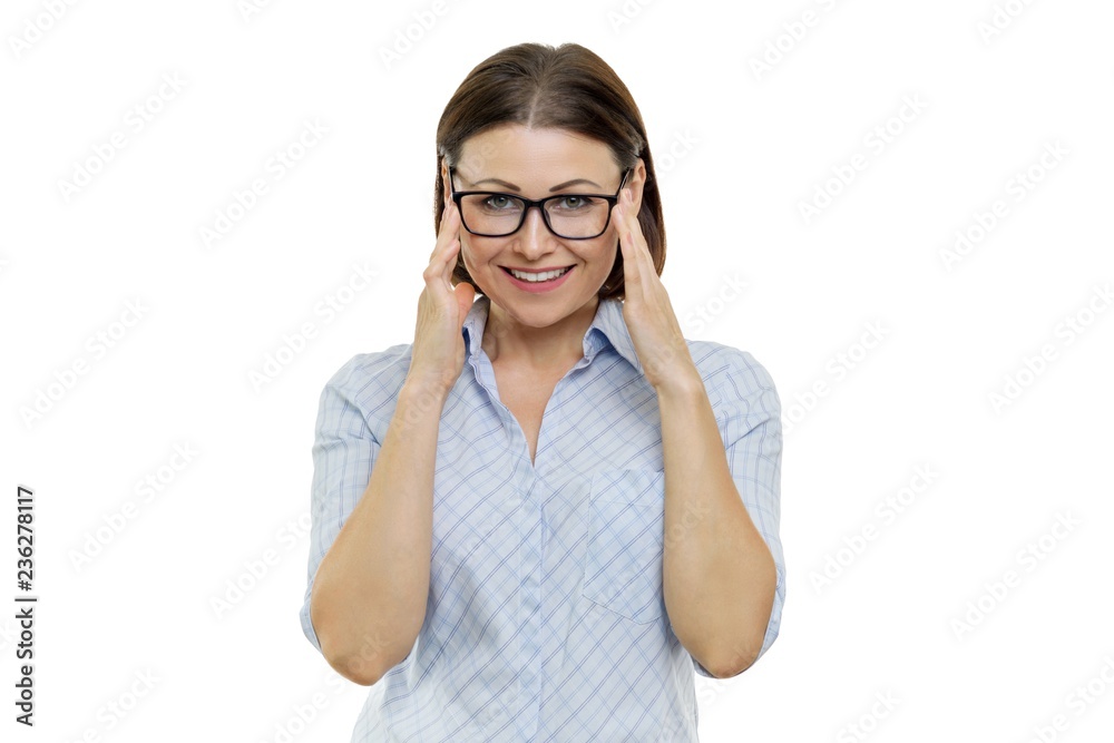 Smiling middle-aged woman with glasses looking at the camera, hands near the glasses, isolated, white background Smiling middle-aged woman with glasses looking at the camera, hands near the glasses, isolated, white background