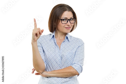 Portrait of mature businesswoman with glasses showing index finger up, isolated on white. Attention sign, idea, showing in place for your text