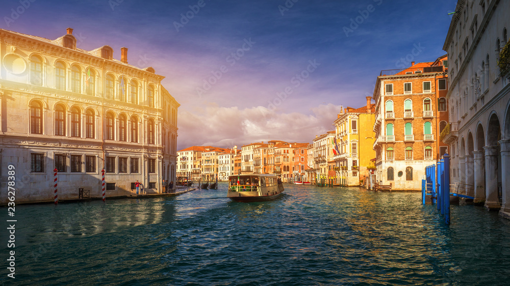 View of the street canal in Venice, Italy. Colorful facades of old Venice houses. Venice is a popular tourist destination of Europe. Venice, Italy.