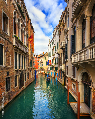 Canal with gondolas in Venice, Italy. Architecture and landmarks of Venice. Venice postcard with Venice gondolas.