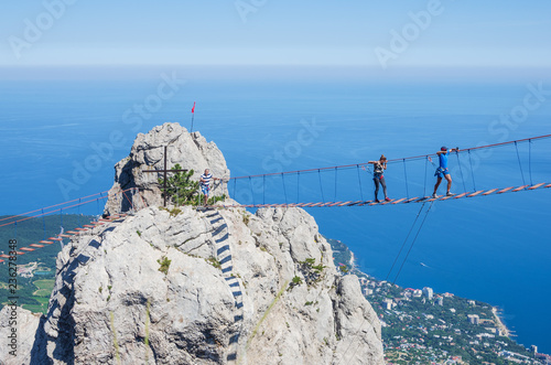 Suspension bridge over the abyss. Russia, Republic of Crimea. 06.13.2018. Suspension bridge on Mount Ai-Petri. Extreme attraction for tourists