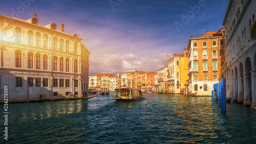 View of the street canal in Venice, Italy. Colorful facades of old Venice houses. Venice is a popular tourist destination of Europe. Venice, Italy.