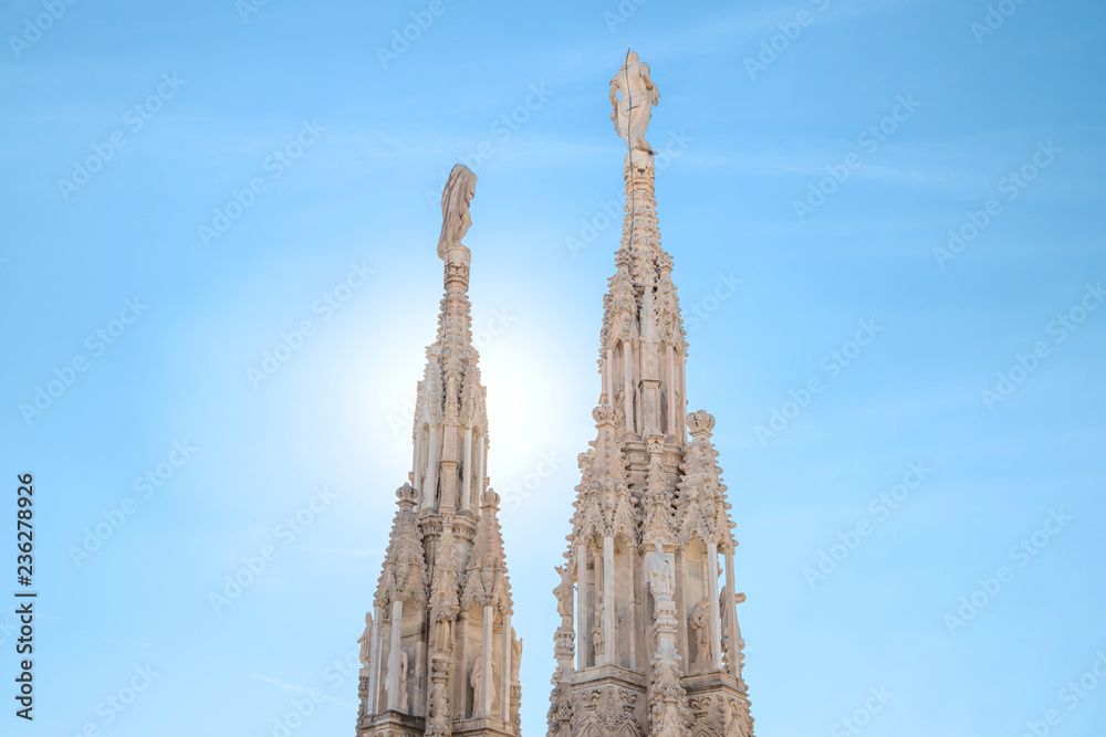 Marble statues - architecture on top of roof Duomo gothic cathedral in Milan, Italy