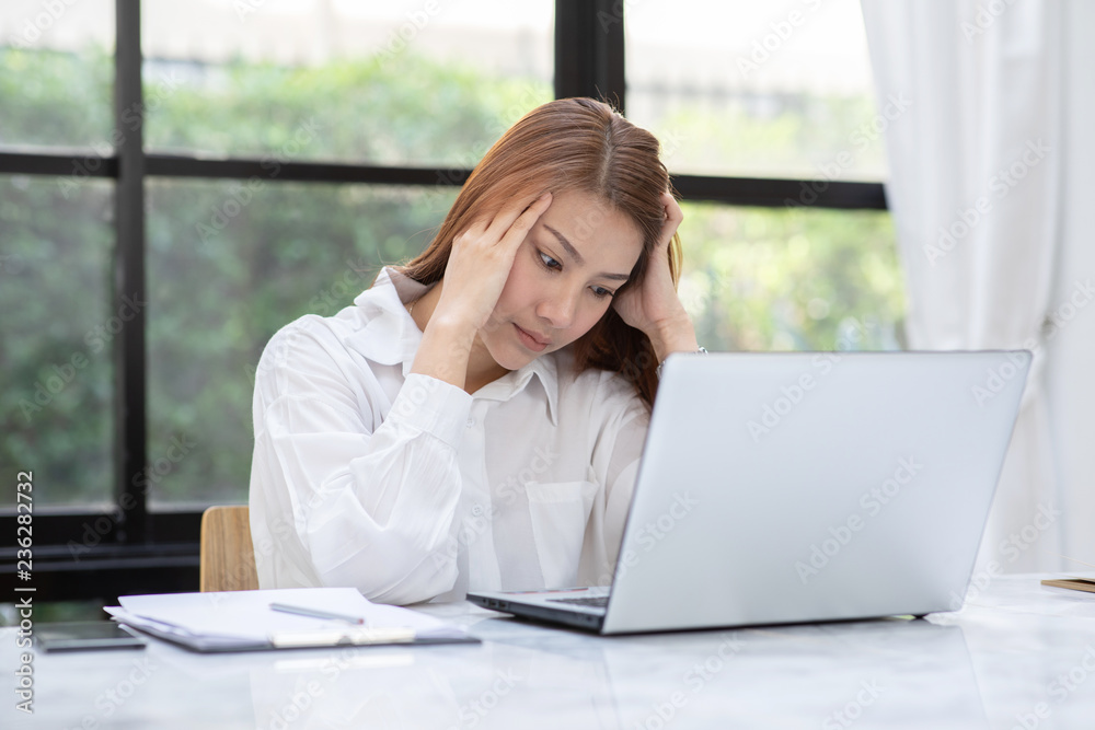 Business Asian woman have a Migraine so headache and stresses of her work Business Asian woman have a Migraine so headache and stresses of her work