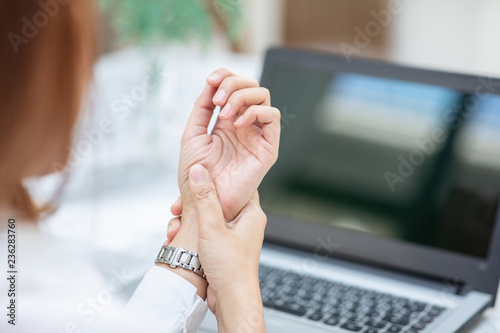 Close up woman have a Carpal Tunnel Syndrome or wrist pain after work hard in office feeling so pain and illness with Office syndrome symptom,Healthcare Office Syndrome Concept,Selective Focus