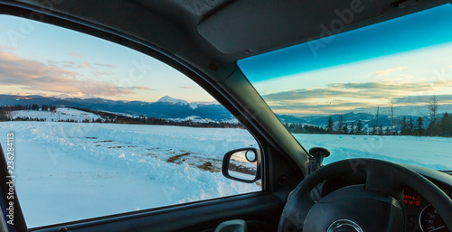Evening winter mountain ridge view thru car windshield