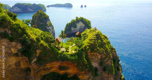 Jungle Tree Houses In Nusa Penida, Indonesia On Cliffs Overlooking Tropical Bay