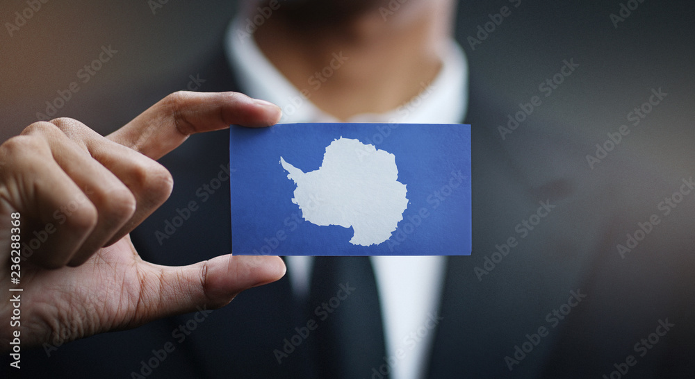 Businessman Holding Card of Antarctica Flag Businessman Holding Card of Antarctica Flag