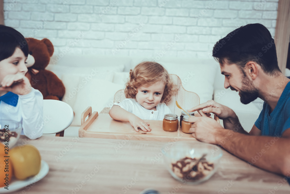 Fototapeta premium Father is Feeding His Sons a Breakfast