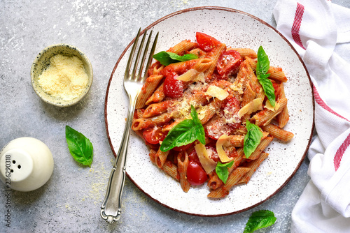 Penne pasta with tomato in red sauce.Top view with copy space.