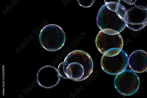 Multicolored soap bubbles close up on a black background 