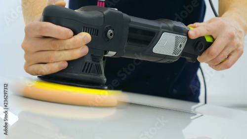 Wallpaper Mural Closely shown as a professional worker polishes the transport (car) body using a polishing tool (machine). Concept from: Auto service, Car Painting, Machine washing. Torontodigital.ca