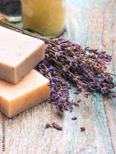 Cosmetic salt for bath with flowers lavender, natural soap on a wooden background with copy space.