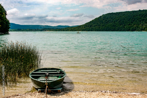 Little boat at Lake Chalain in Jura mountains, France.