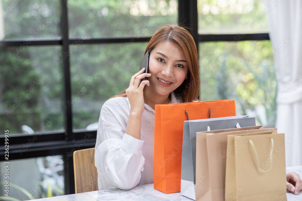 Fototapeta premium Beautiful Attractive Asian woman using smartphone for shopping online transform to online payment feeling so enjoy and happiness,Shopping Technology concept