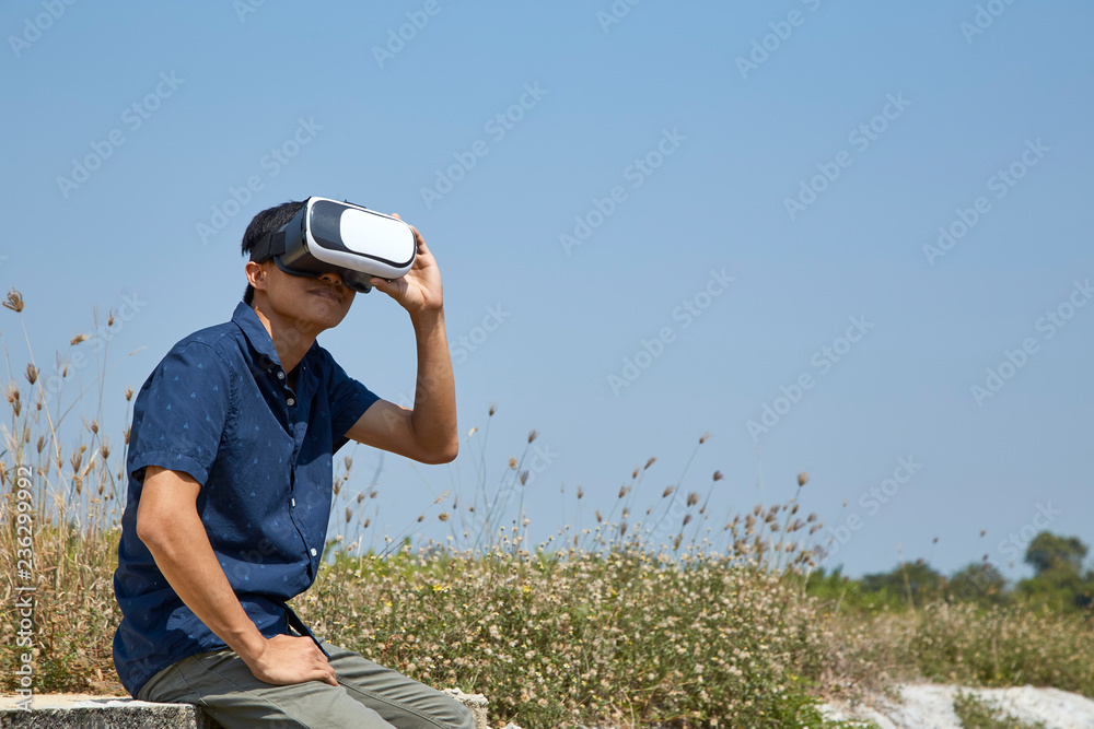 Asian man using the virtual reality headset Asian man using the virtual reality headset