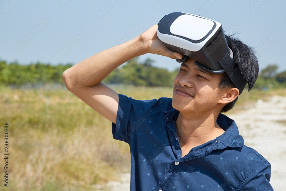 Asian man using the virtual reality headset Asian man using the virtual reality headset