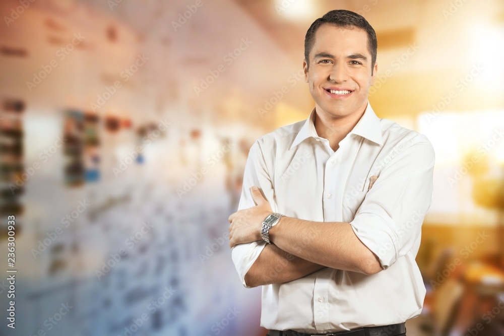 Confident businessman with crossed arms isolated on white Confident businessman with crossed arms isolated on white