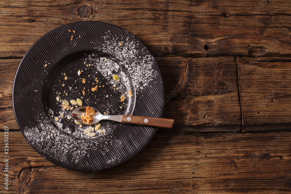 empty dirty plate on old wooden background empty dirty plate on old wooden background