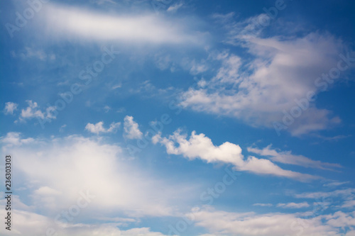 White curly clouds in a blue sky. Sky background © beletskaya18