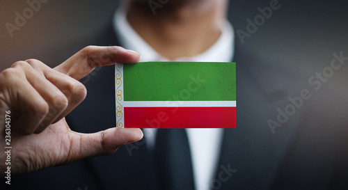 Businessman Holding Card of Chechen Republic Flag