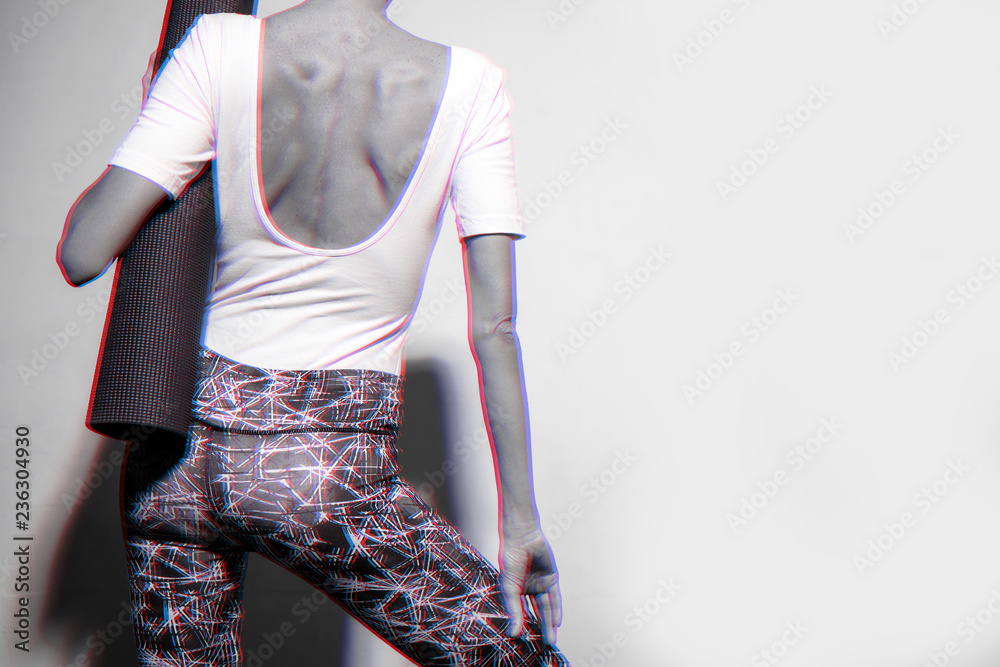 Yoga girl with yoga mat walking to the 