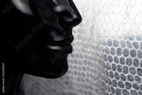 black of fashion mannequin face with white bubble plastic for packaging background