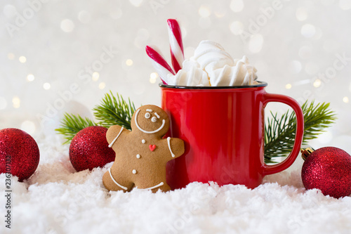 Cozy winter composition with a cup of hot chocolate with marshmallows gingerbread man cookies  on a light festive background. photo