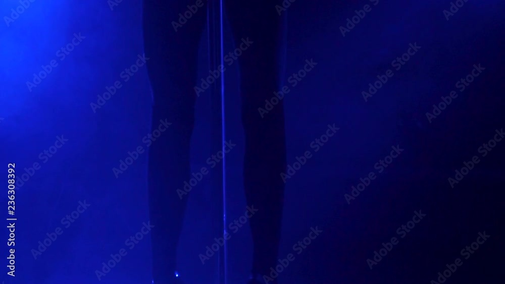 Slender legs of pole dancer in high heels, close-up. Close-up of stripper shoes in the club. Pole dance.