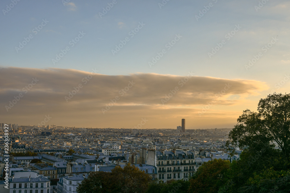View from Sacre Coeur of Paris city with the Tour Montparnasse, a 210-metre office skyscraper located in the Montparnasse area, at sunset in autumn