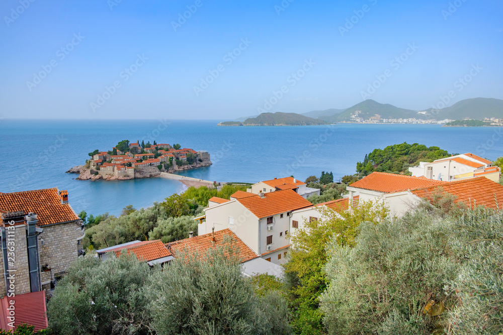 Scenic view of Saint Stephen (Sveti Stefan) island in Adriatic sea connected with coast by bridge. Beautiful aerial photo of luxury resort on Adriatic sea.