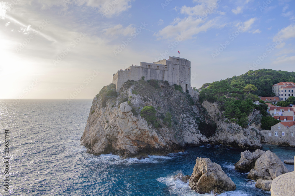 Scenic view of Fort Lovrijenac in ancient touristic town Dubrovnik in Croatia. Beautiful aerial view of fortress on cliff in sunset light in old european resort on Adriatic sea.