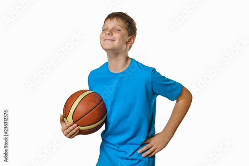 portrait of a teenage boy with a basketball ball on a white background, isolate, smiling with eyes closed © elena
