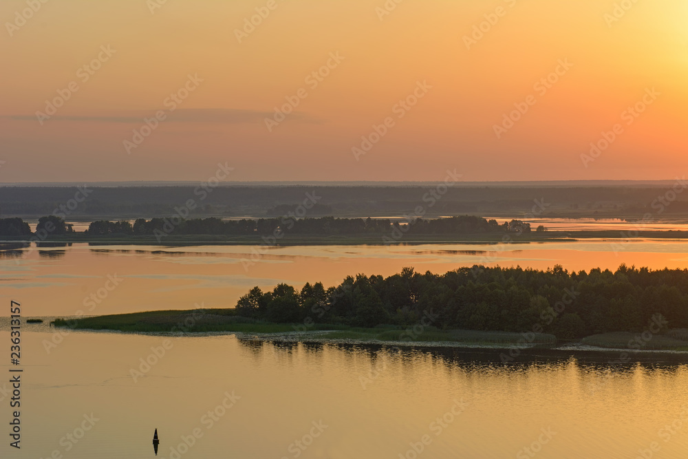 Sunrise over the river in the summer