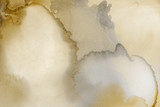 Gold alcohol ink wash texture on clean paper background. Liquid paint flow. Transparent ethereal effect.