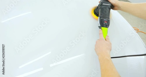 Wallpaper Mural Closely shown as a professional worker polishes the transport (car) body using a polishing tool (machine). Concept from: Auto service, Car Painting, Machine washing. Torontodigital.ca