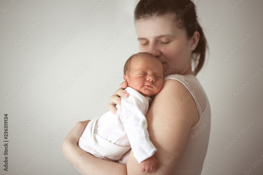 Gentle mother holds sleeping newborn baby Gentle mother holds sleeping newborn baby