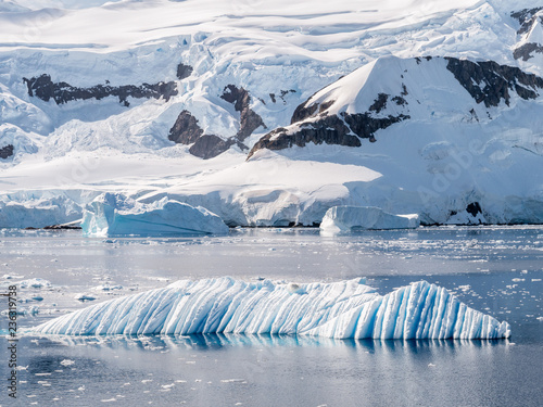 Wind and water sculpted iceberg drifting in Andvord Bay near Neko Harbor, Antarctic Peninsula, Antarctica photo