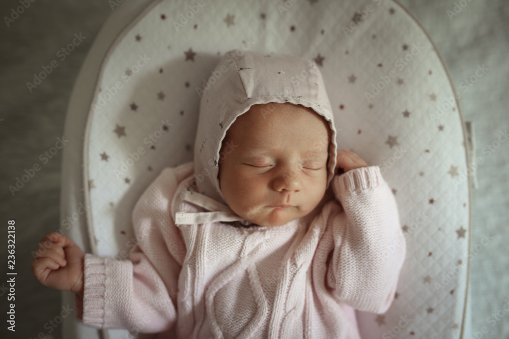 sleeping newborn girl in a knitted dress and cap sleeping newborn girl in a knitted dress and cap