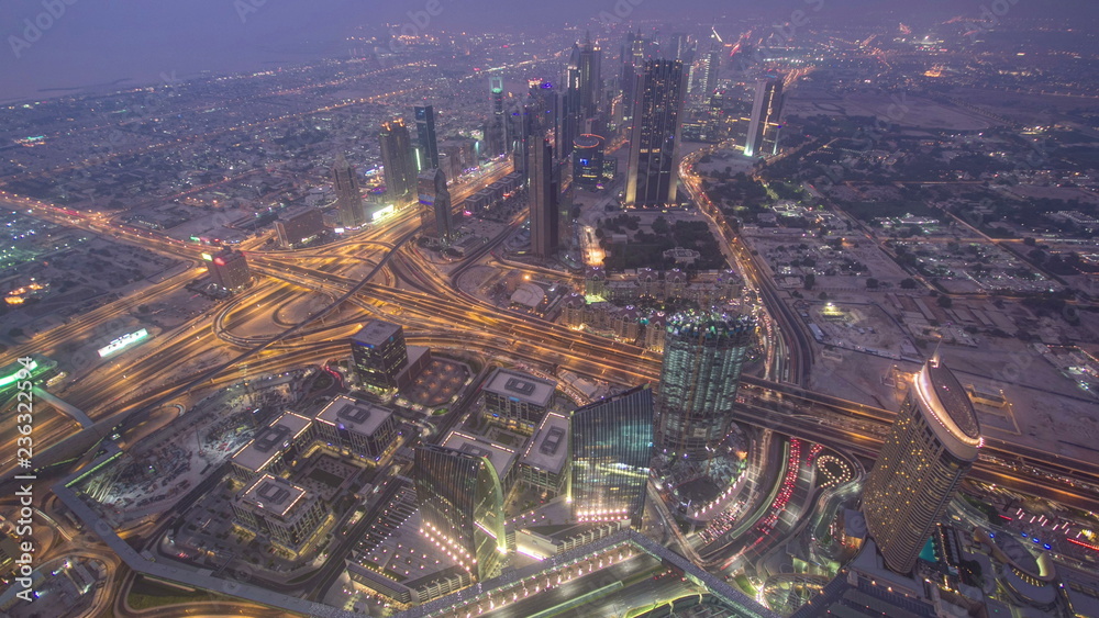 Obraz premium Dubai downtown from day to night transition with city lights from Burj Khalifa timelapse