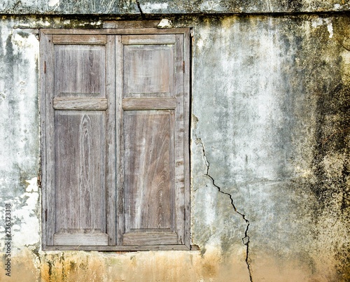 old brown wood window at antique concrete house in thailand